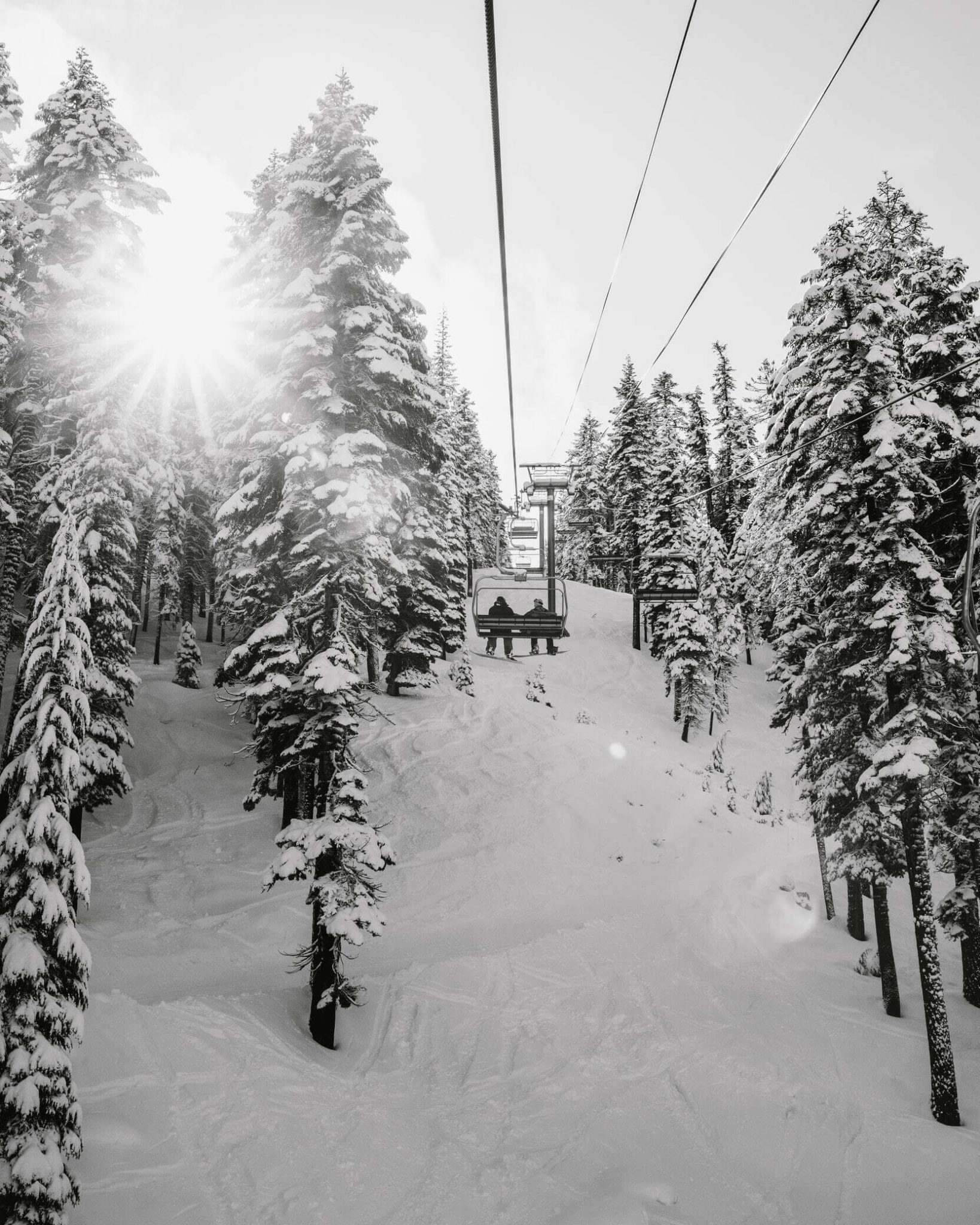 A couple ride the ski lift together during their romantic getaway to Jackson Hole, WY.