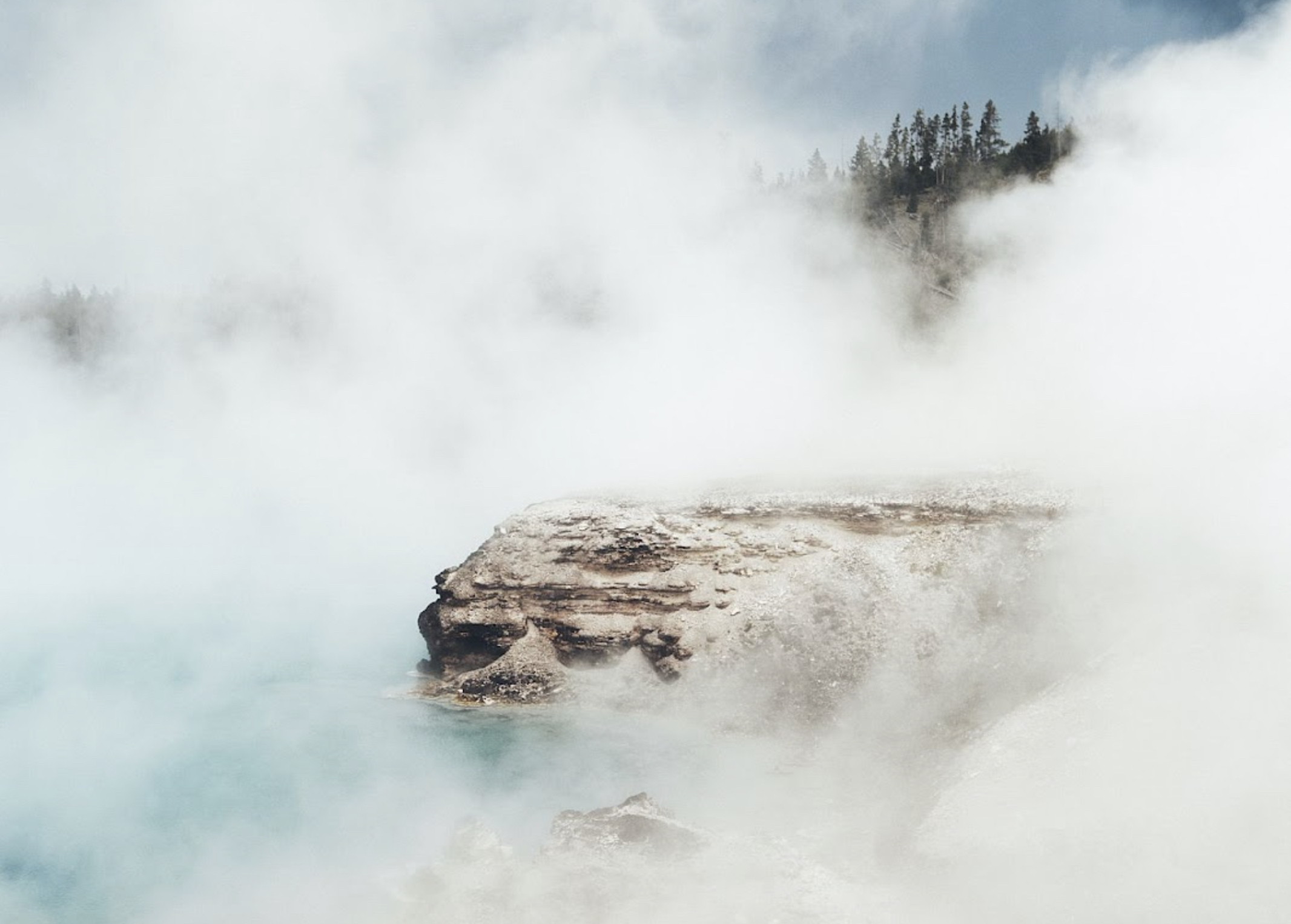 Mist rises over thermal springs in Yellowstone National Park